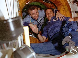 Chilton is greeted by Mir-21 Commander Yuri Onufriyenko in the open hatch. 